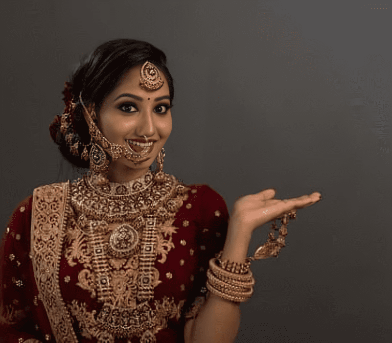 girl is in bridal makeup showing left hand